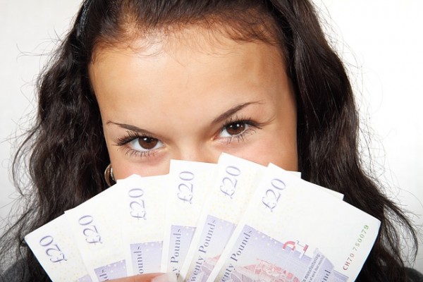 Woman holding British banknotes